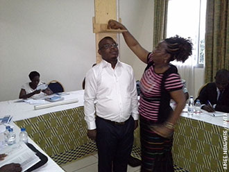 Participants at the Côte d’Ivoire training use a height board during a microteaching session. (Photo by Aimee Nibagwire)