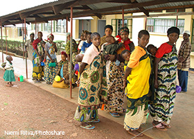 group of people waiting in line outside a clinic