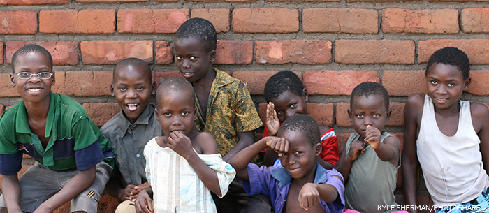 children standing by a wall