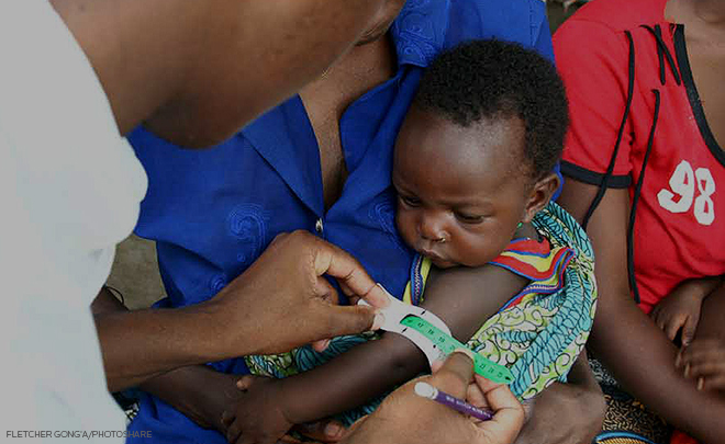 baby getting their arm measured