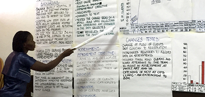 woman pointing to writings posted to a wall