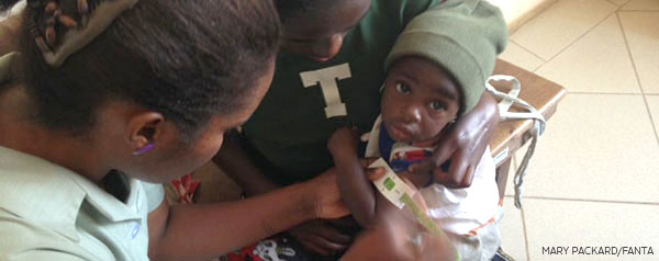 Child getting arm circumference measured