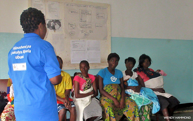 photo of someone addressing a row of seated mothers and pregnant ladies