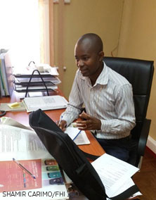 young man works at desk