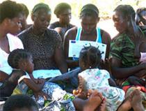 Group of mothers looking over family planning materials.