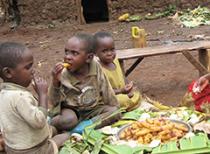 Children in Uganda eat a meal. Otushabire Tibyangye/Photoshare