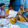 © 2009 Hanmanta V. Wadgave, Courtesy of Photoshare. A self-help group (SHG) member provides a mother with information on infant and newborn care during a home visit in India.